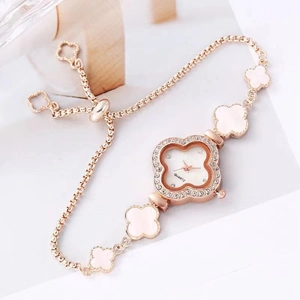 Elegant gold clover bracelet watch for women with rhinestone bezel and white dial