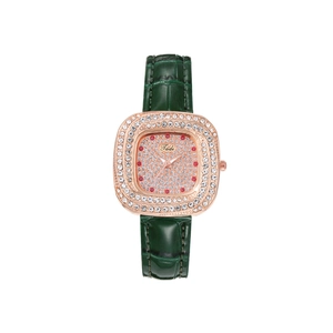 Detail of rose gold square watch with green crocodile strap and crystal bezel embellishment