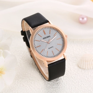 Detail of rose gold ladies watch with silver glitter dial and black leather strap