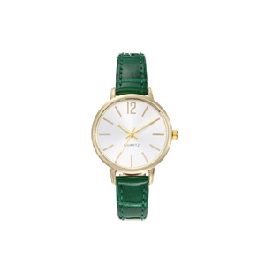 Detail view of small round gold watch case with white dial and green faux leather strap