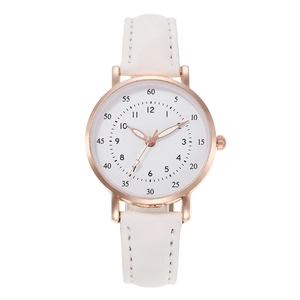 Detail of rose gold watch case with white leather strap and numeric dial scale