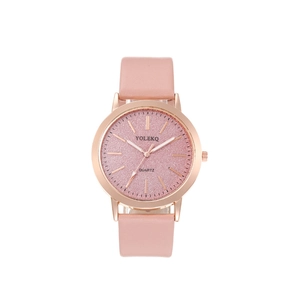 Close-up of pink glitter watch dial with rose gold case and leather strap detail