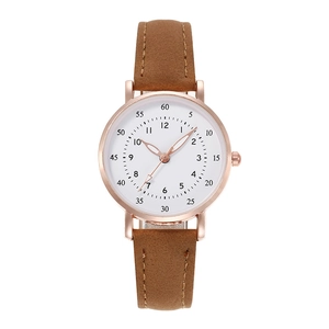 Detail of rose gold quartz watch with white dial and brown frosted leather strap