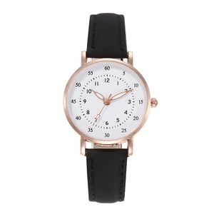 Minimalist quartz watch for women with rose gold case and black leather strap on white
