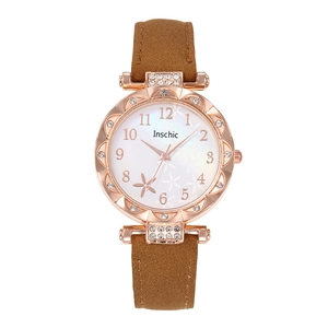 Women's rose gold watch with floral dial, crystal bezel, and brown leather strap