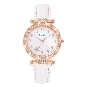 Detailed macro of white leather strap watch with rhinestone bezel and floral dial pattern