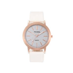 Close-up of rose gold quartz watch with silver glitter dial and white leather strap