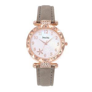 Detail of rose gold quartz watch with floral white dial and grey suede strap for women