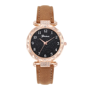 Detail of rose gold diamond watch case with starry dial and brown leather strap