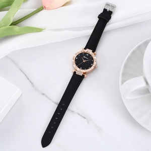 Elegant women's watch featuring a black starry dial and rose gold case on marble