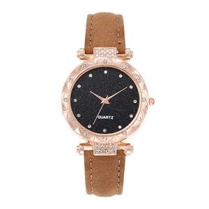 Detailed macro of starry black dial watch with rose gold case and rhinestone bezel