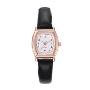 Vintage tonneau rose gold quartz watch for women with black leather strap on white background