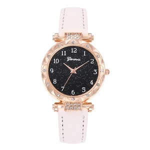Detail of rose gold watch case with crystal bezel and starry sky dial on white leather strap
