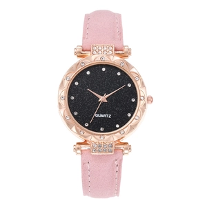 Detail of a pink leather strap watch with rose gold diamond case and starry sky dial