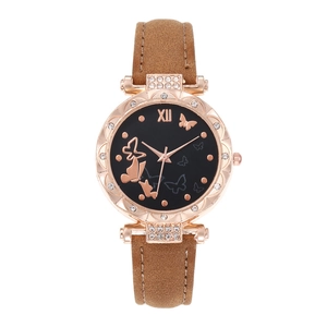 Detail of rose gold bezel with rhinestones and butterfly patterns on the black dial