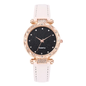 Detail of rose gold quartz watch with starry dial, crystal bezel and white leather strap