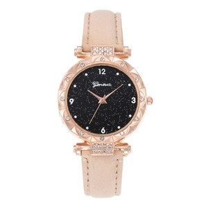Detail of starry sky dial with crystal bezel and beige leather strap on women's watch