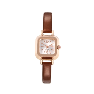 Detail of square rose gold watch dial with brown leather strap on white background
