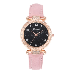 Detail of pink suede strap and rose gold rhinestone case on starry sky dial quartz watch