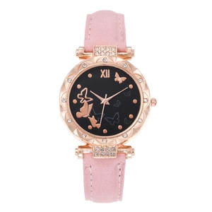 Detailed macro view of butterfly dial with rhinestones on rose gold women's watch