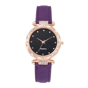 Detail of purple quartz watch for women with starry dial and rhinestone bezel on white background