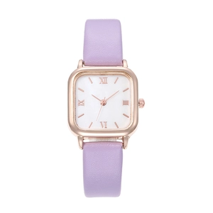 Detail view of square rose gold watch case with lilac leather strap and roman numerals