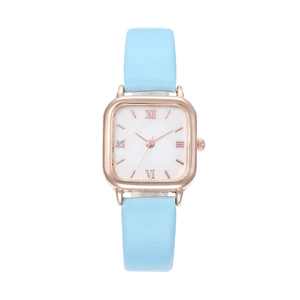 Detail of square rose gold watch case with marble dial and light blue leather strap