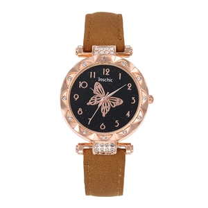 Detail of rose gold watch with butterfly star dial and sparkling crystal bezel