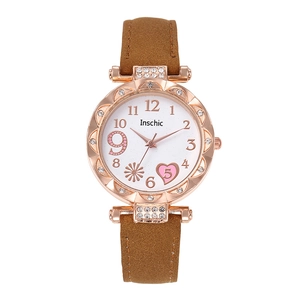 Detail of rose gold case with crystals and heart-shaped markers on a quartz watch