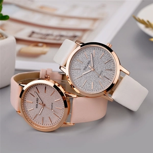 Detail of pink and white quartz watches with glitter star dials and rose gold cases