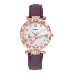 Detail of rose gold watch case with crystal inlay and purple leather strap