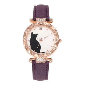 Detail of rose gold cat watch with purple matte strap and rhinestone accents