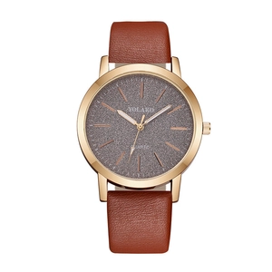 Macro detail of matte starry dial with rose gold markers and brown leather strap
