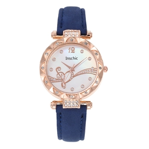 Detail of rose gold scalloped watch case with rhinestone musical notes on the dial