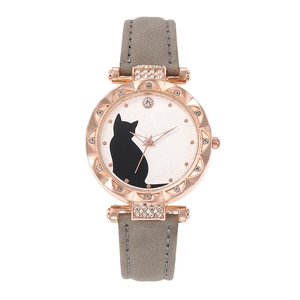 Detail of rose gold cat watch face with rhinestone bezel and grey leather strap