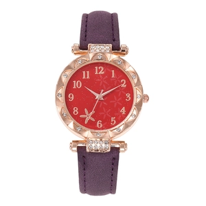Detailed view of women's watch with red floral dial, crystal bezel and purple strap