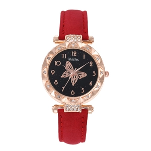 Elegant ladies quartz watch with butterfly dial and red suede strap on white background