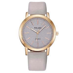 Detail of grey leather strap and glitter dial on a minimalist quartz watch