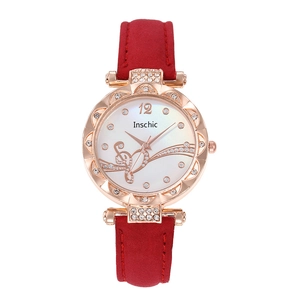 Detailed view of red frosted strap and rose gold watch case with crystal accents
