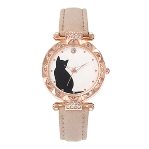 Women's quartz watch with cat motif dial, rhinestone rose gold case, and beige leather strap