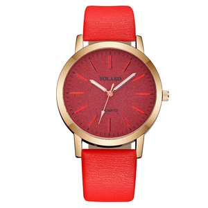 Detailed close-up of YOLAKO quartz watch with red frosted dial and golden metal case