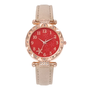 Women's quartz watch with gold rhinestone bezel, red floral dial, and beige suede strap