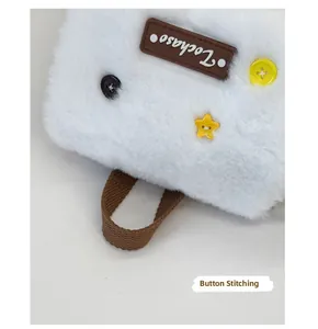 Detail of hand-sewn buttons and plush fabric on the white rabbit-ear backpack