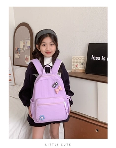 Detail of purple school bag with cute bow accents and floral decor for girls
