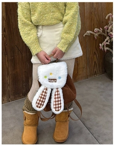 Close-up of children plush rabbit ear backpack with corduroy texture and star decor
