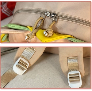 Detail of high-quality metal double zipper with woven puller on beige canvas backpack