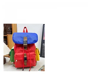 Detail of red and blue color-blocked kids' hiking backpack with canvas texture