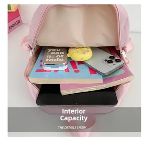 Detailed interior of pink school bag showing large capacity for books and tablet
