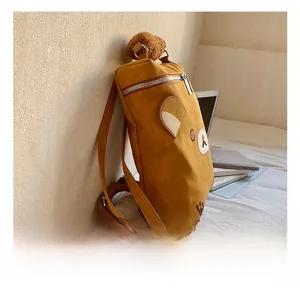 Close-up of yellow bear backpack featuring plush ears and high-quality silver zippers
