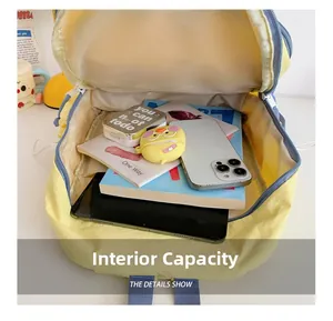 Spacious interior of yellow canvas backpack showing laptop and books storage